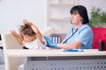 Little girl visiting old female doctor Royalty Free Stock Photo