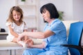 Little girl visiting old female doctor Royalty Free Stock Photo