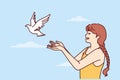 Little girl volunteers teenager sets dove free and lets bird fly towards sky for family reunion