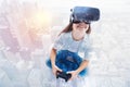 Little girl in VR headset holding game controller