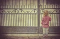 Little girl waiting alone at the gate