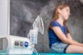 Little girl waiting for medical inhalation treatment with a nebulizer Royalty Free Stock Photo