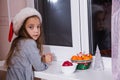 Little girl waiting Santa Claus magic Christmas window winter dark tangerine tale Royalty Free Stock Photo