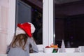 Little girl waiting Santa Claus magic Christmas window winter dark tangerine tale Royalty Free Stock Photo