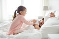 Little girl waking her sleeping father up in bed Royalty Free Stock Photo