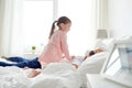 Little girl waking her sleeping father up in bed Royalty Free Stock Photo