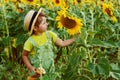 Little girl on a walk in the field with sunflowers Royalty Free Stock Photo