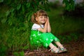 Little girl walk in green garden in summer day Royalty Free Stock Photo