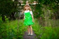 Little girl walk in green garden in summer day Royalty Free Stock Photo