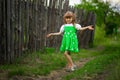 Little girl walk in green garden in summer day Royalty Free Stock Photo