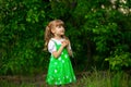 Little girl walk in green garden in summer day Royalty Free Stock Photo