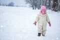 Little girl walking alone during cold winter day outdoors. Lot of copy space. Royalty Free Stock Photo