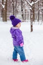 Little girl walking alone outside, kids full height portrait.