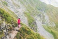 Little girl walking alone on a path on top of a mountain Royalty Free Stock Photo