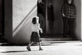 Little girl walking alone on the street