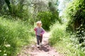 Little girl walking along the path in the park Royalty Free Stock Photo