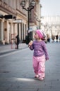 A little girl walking along the street with an ice-creame