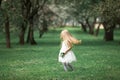 Little girl is walking in an apple garden Royalty Free Stock Photo