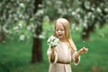 Little girl is walking in an apple garden Royalty Free Stock Photo