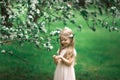 Little girl is walking in an apple garden Royalty Free Stock Photo