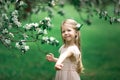Little girl is walking in an apple garden Royalty Free Stock Photo