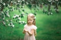 Little girl is walking in an apple garden Royalty Free Stock Photo