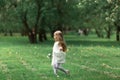 Little girl is walking in an apple garden Royalty Free Stock Photo