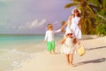 Little girl walking on the beach with family after Royalty Free Stock Photo