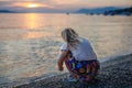 Little girl walking on beautiful ocean beach. Happy preschool child play by sunset on sea beach. Family vacations with Royalty Free Stock Photo