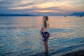 Little girl walking on beautiful ocean beach. Happy preschool child play by sunset on sea beach. Family vacations with Royalty Free Stock Photo