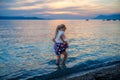 Little girl walking on beautiful ocean beach. Happy preschool child play by sunset on sea beach. Family vacations with Royalty Free Stock Photo