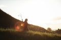 Little girl is walking with butterfly net and catching butterflies on the green hills on sunny summer day. copy space Royalty Free Stock Photo