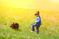 Little girl walking with dog Royalty Free Stock Photo