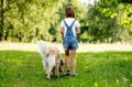 Little girl walking dog on meadow Royalty Free Stock Photo