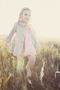 Little girl walking through field