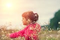 Little girl walking on the flower meadow Royalty Free Stock Photo