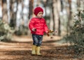 Little girl walking in the forest