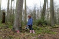 Little girl walking with her dog in the forest. Happy childhood Royalty Free Stock Photo