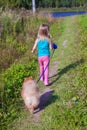 Little girl walking with her ??dog on a leash Royalty Free Stock Photo