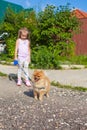 Little girl walking with her ??dog on a leash Royalty Free Stock Photo