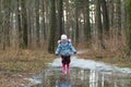 Little girl walking on icy puddle Royalty Free Stock Photo