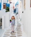 Little girl walking the narrow alley in Greece Royalty Free Stock Photo