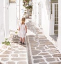 Little girl walking the narrow alley in Greece Royalty Free Stock Photo