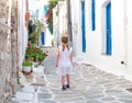 Little girl walking the narrow alley in Greece Royalty Free Stock Photo