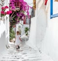 Little girl walking the narrow alley in Greece Royalty Free Stock Photo