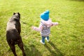 Little girl is walking in the park with her big dog Royalty Free Stock Photo