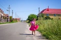 Little girl is walking on the road in the village Royalty Free Stock Photo