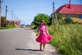 Little girl is walking on the road in the village Royalty Free Stock Photo