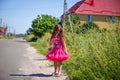 Little girl is walking on the road in the village Royalty Free Stock Photo