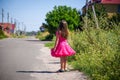 Little girl is walking on the road in the village Royalty Free Stock Photo